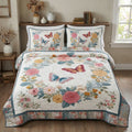 Butterfly Meadow Retreat quilted 3-piece bedding set on a made bed with two matching pillow shams