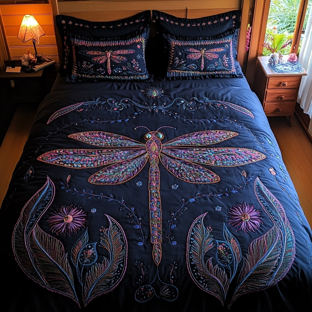 Charcoal Dragonfly Whisper quilted 3-piece bedding set on a made bed with two matching pillow shams