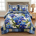 Classic Blue Floral quilted 3-piece bedding set on a made bed with two matching pillow shams