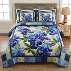 Classic Blue Floral quilted 3-piece bedding set on a made bed with two matching pillow shams