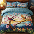 Colorful Birds quilted 3-piece bedding set on a made bed with two matching pillow shams