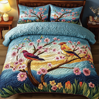 Colorful Birds quilted 3-piece bedding set on a made bed with two matching pillow shams
