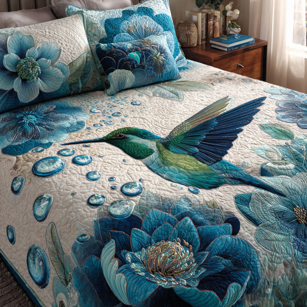Hummingbird Bloom Animal quilted 3-piece bedding set on a made bed with two matching pillow shams