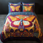 Orange Mystic Butterfly quilted 3-piece bedding set on a made bed with two matching pillow shams