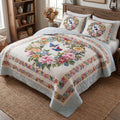 Pastel Garden Dream quilted 3-piece bedding set on a made bed with two matching pillow shams