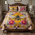 Patchwork Pollinator quilted 3-piece bedding set on a made bed with two matching pillow shams