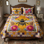 Patchwork Pollinator quilted 3-piece bedding set on a made bed with two matching pillow shams