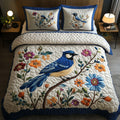 Perch And Petals quilted 3-piece bedding set on a made bed with two matching pillow shams