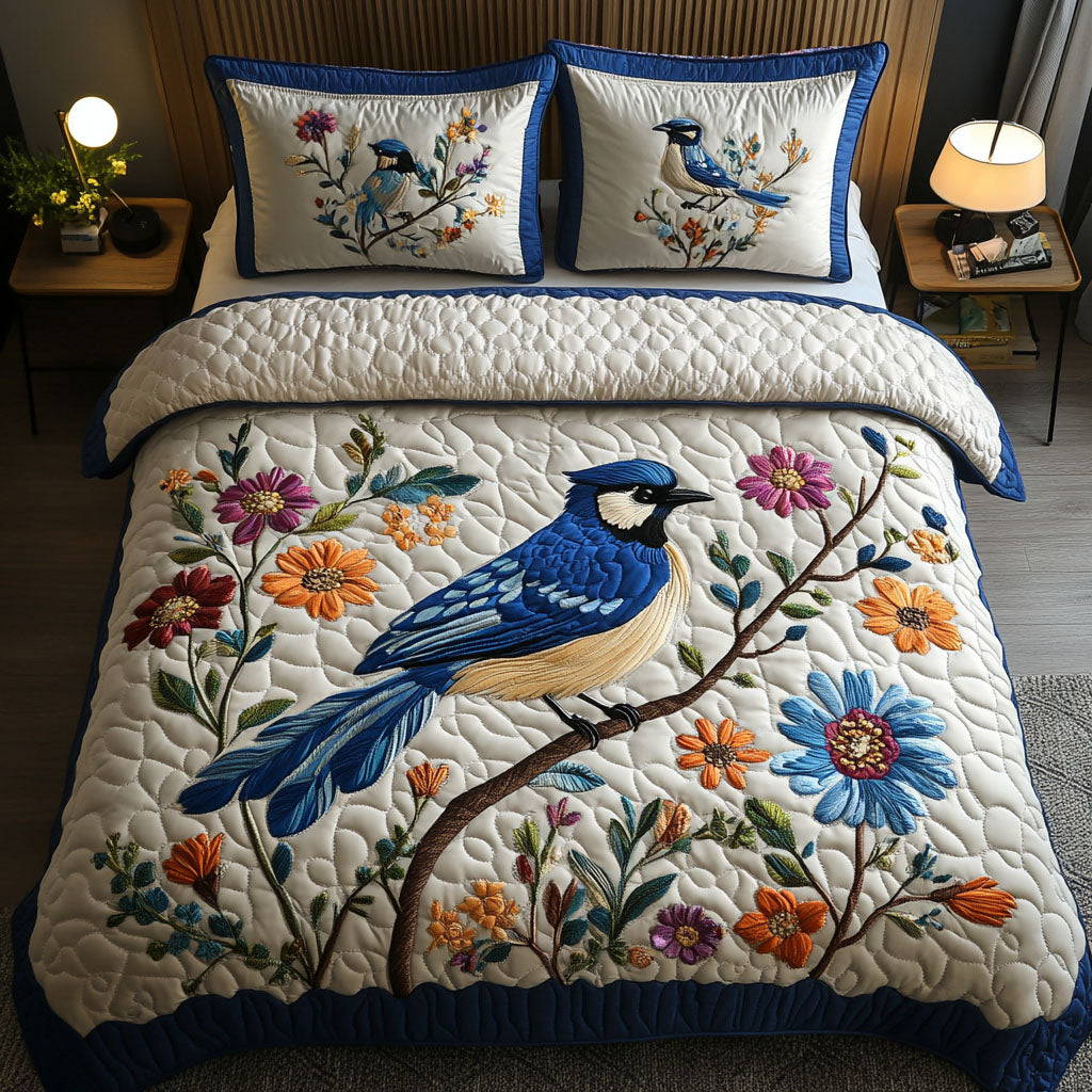 Perch And Petals quilted 3-piece bedding set on a made bed with two matching pillow shams