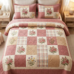 Pink Meadow quilted 3-piece bedding set on a made bed with two matching pillow shams
