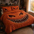 Pumpkin Grin quilted 3-piece bedding set on a made bed with two matching pillow shams