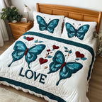 Transformative Love quilted 3-piece bedding set on a made bed with two matching pillow shams