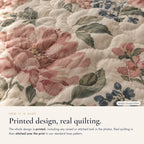 Close-up: the design is printed, and real quilting is stitched over the print in a standard loop pattern (sample design shown)