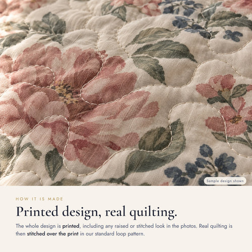 Close-up: the design is printed, and real quilting is stitched over the print in a standard loop pattern (sample design shown)