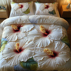 Whispering White Blooms quilted 3-piece bedding set on a made bed with two matching pillow shams